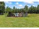Chicken coop sitting on a grassy expansive backyard lawn at 705 S Bethany Rd, Mcdonough, GA 30252