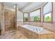 Bright bathroom showcasing a soaking tub with jets, and walk in shower at 705 S Bethany Rd, Mcdonough, GA 30252