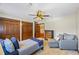 Bedroom with a ceiling fan, natural light, and hardwood closet doors at 705 S Bethany Rd, Mcdonough, GA 30252