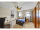Bedroom with a ceiling fan, natural light, and beautiful hardwood door at 705 S Bethany Rd, Mcdonough, GA 30252