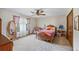 Bright bedroom with natural light, classic furniture, ceiling fan, and plush carpeting at 705 S Bethany Rd, Mcdonough, GA 30252