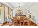 Bright dining room with wood floors, chandelier, large windows, and a view of backyard at 705 S Bethany Rd, Mcdonough, GA 30252