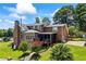 A brick two-story home with a well-manicured yard, porch and trees at 705 S Bethany Rd, Mcdonough, GA 30252