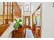 Inviting foyer featuring hardwood floors, a wooden staircase, and elegant furnishings at 705 S Bethany Rd, Mcdonough, GA 30252
