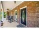 Inviting front porch with brick detailing, rocking chairs, and a welcoming entryway at 705 S Bethany Rd, Mcdonough, GA 30252