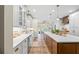 Bright kitchen with white cabinets, quartz countertops, a large island, and stainless steel appliances at 705 S Bethany Rd, Mcdonough, GA 30252