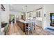Eat-in kitchen featuring a large kitchen island, white cabinets, stainless steel appliances, and hardwood floors at 705 S Bethany Rd, Mcdonough, GA 30252