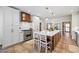 Well-lit kitchen with a large island, stainless steel range, a wood-trimmed range hood, and bar stool seating at 705 S Bethany Rd, Mcdonough, GA 30252