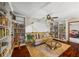 Living room with hardwood floors, built in shelves, ceiling fan, and comfortable seating at 705 S Bethany Rd, Mcdonough, GA 30252