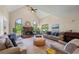Living room with high ceilings, fireplace, large windows, and hardwood floors at 705 S Bethany Rd, Mcdonough, GA 30252