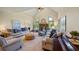 Spacious living room with high ceilings, fireplace, large windows, hardwood floors, and a piano at 705 S Bethany Rd, Mcdonough, GA 30252