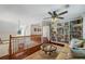 Spacious living room featuring hardwood floors, built-in bookshelves, and a decorative glass table at 705 S Bethany Rd, Mcdonough, GA 30252