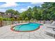 Beautiful in-ground swimming pool surrounded by a white fence and lush greenery at 705 S Bethany Rd, Mcdonough, GA 30252