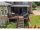Screened porch with outdoor furniture and stairs leading down to the back yard at 705 S Bethany Rd, Mcdonough, GA 30252