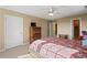 Cozy bedroom features a floral bedspread, television, drawers, and a ceiling fan for comfortable living at 922 Florence Rd, Douglasville, GA 30134
