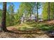 Stately home with a deck and screened porch nestled among mature trees on a lush, landscaped lot at 922 Florence Rd, Douglasville, GA 30134