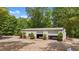 Spacious garage with classic cars inside, surrounded by well-maintained landscaping and gravel driveway at 922 Florence Rd, Douglasville, GA 30134