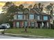 Charming two-story home with brick and stone exterior, dark shutters, and well-manicured lawn under a colorful sky at 2304 Northglenn Ct, Conyers, GA 30013
