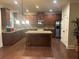 Well-equipped kitchen with an island, dark wood cabinets, granite countertops, and stainless steel appliances at 2304 Northglenn Ct, Conyers, GA 30013