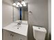 Well-lit bathroom with a white vanity, a modern mirror, and a toilet at 365 Wesley Mill Pl, Villa Rica, GA 30180