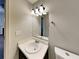 This modern bathroom features a vanity with countertop and a stylish mirror with modern lighting at 365 Wesley Mill Pl, Villa Rica, GA 30180