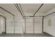 Spacious garage featuring two doors and finished walls and ceiling at 365 Wesley Mill Pl, Villa Rica, GA 30180