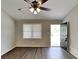 Bright living room with wood-look floors, ceiling fan, and access to the outdoor space at 365 Wesley Mill Pl, Villa Rica, GA 30180