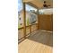 View of outdoor living space with wood flooring, wooden rails, a ceiling fan, and an adjacent privacy fence at 559 Fundao Ln # 21, Lawrenceville, GA 30046