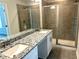 Beautiful bathroom featuring a double vanity with granite counters and dual glass enclosed shower at 559 Fundao Ln # 21, Lawrenceville, GA 30046