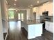 Modern kitchen features white cabinets, a granite countertop island, and stainless steel appliances at 559 Fundao Ln # 21, Lawrenceville, GA 30046