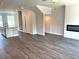 Open living space featuring luxury vinyl flooring, a modern fireplace and lots of natural light at 559 Fundao Ln # 21, Lawrenceville, GA 30046