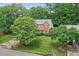 A bird's eye view of a beautiful neighborhood showcasing a well-manicured lawn with mature trees at 1065 Bookhout Drive Dr, Cumming, GA 30041