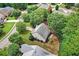 Birds eye view of a house nestled among trees, showcasing the neighborhood and mature landscaping at 1065 Bookhout Drive Dr, Cumming, GA 30041