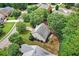 A bird's eye view of a home in a beautiful neighborhood with mature trees and lush greenery at 1065 Bookhout Drive Dr, Cumming, GA 30041