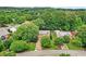 Beautiful aerial view of a red brick home surrounded by lush trees and greenery at 1065 Bookhout Drive Dr, Cumming, GA 30041