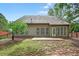 A view of the back of the home with plentiful windows and a walk-out patio at 1065 Bookhout Drive Dr, Cumming, GA 30041