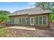 A view of the back of the home with plentiful windows and a walk-out patio at 1065 Bookhout Drive Dr, Cumming, GA 30041