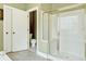 Bathroom featuring a glass enclosed shower, tile floor, and toilet in adjacent room at 1065 Bookhout Drive Dr, Cumming, GA 30041