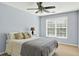 Comfortable bedroom with a ceiling fan, large window, and neutral decor at 1065 Bookhout Drive Dr, Cumming, GA 30041