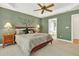 Relaxing bedroom with a bed, ceiling fan, tray ceiling and decorative wall art at 1065 Bookhout Drive Dr, Cumming, GA 30041