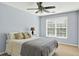 Comfortable bedroom featuring a ceiling fan, window, and neutral decor at 1065 Bookhout Drive Dr, Cumming, GA 30041