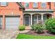 Close up of a beautiful traditional brick home showcasing an inviting entrance and a two-car garage at 1065 Bookhout Drive Dr, Cumming, GA 30041