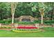 Beautiful Long Lake community entrance with stone signage and lush landscaping at 1065 Bookhout Drive Dr, Cumming, GA 30041