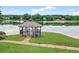 Scenic gazebo on the water's edge, perfect for relaxing, enjoying water views, and serene outdoor gatherings at 1065 Bookhout Drive Dr, Cumming, GA 30041