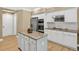Bright kitchen featuring an island with granite countertops and white cabinetry at 1065 Bookhout Drive Dr, Cumming, GA 30041