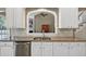 Bright kitchen featuring a granite countertop, stainless steel sink, and ample cabinet space at 1065 Bookhout Drive Dr, Cumming, GA 30041