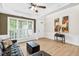 Inviting living room featuring wood floors, tray ceiling, large window, and modern decor at 1065 Bookhout Drive Dr, Cumming, GA 30041