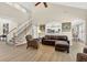 Open living space featuring a staircase, kitchen view, and neutral decor at 1065 Bookhout Drive Dr, Cumming, GA 30041