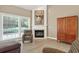 Cozy living room featuring a fireplace, large windows, and comfortable seating at 1065 Bookhout Drive Dr, Cumming, GA 30041