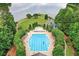 Aerial view of large community pool and surrounding greenery near a lake at 1065 Bookhout Drive Dr, Cumming, GA 30041